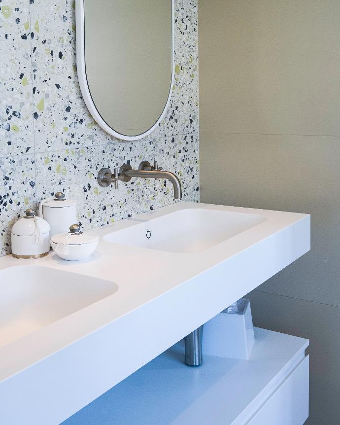 Wall hung double Peace basin in Corian in and cabinet by Riluxa in a studio designed by Lysa Tsouli of Studio Carrez.