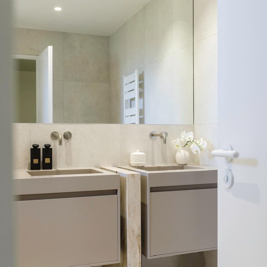 High end bathroom by Studio Carrez with double vanity units made of Corian by Riluxa