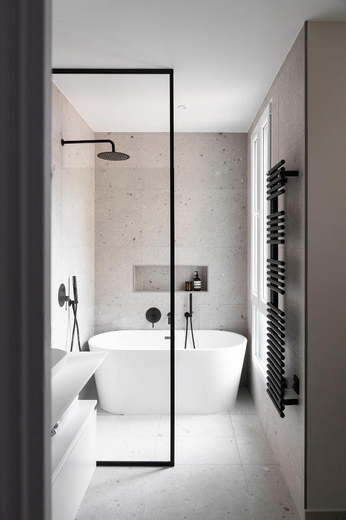 A freestanding Bruges bathtub, bathroom cabinet and washbasin from Riluxa in a bathroom designed by Alak Studio