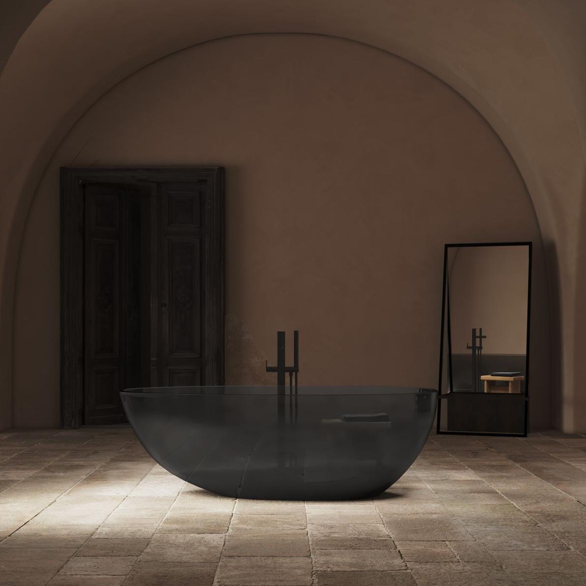 A Toulouse freestanding bath made from translucent resin in a dark and moody bathroom by Riluxa